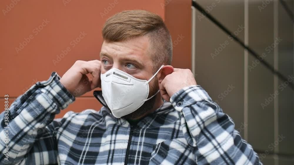 Happy positive cured pandemic man takes off his medical mask of coronavirus protection outside.Concept of healthcare and safety life Happy positive cured pandemic man takes off his medical mask of coronavirus protection outside.Concept of healthcare and safety life