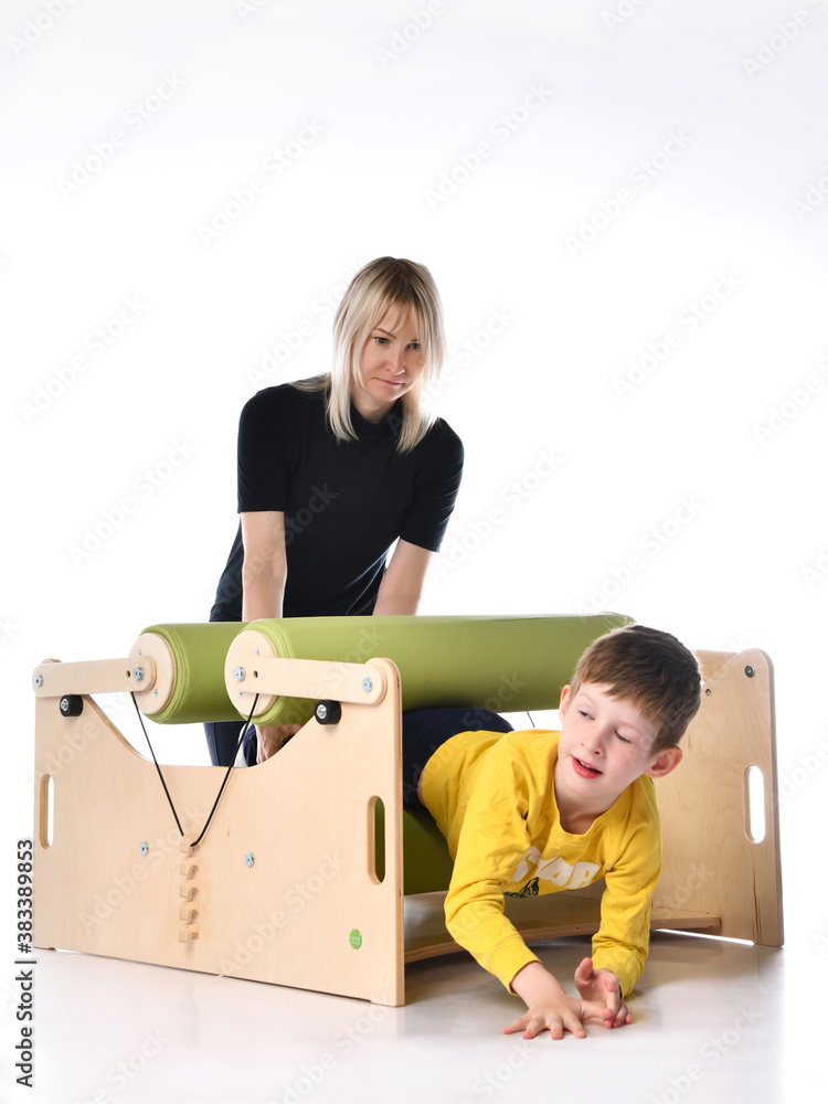 Boy and her mother showing principles of training on compact exercise ...