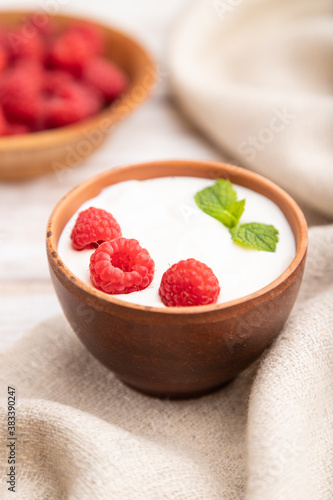Wallpaper Mural Yogurt with raspberry in clay cups on white wooden background. Side view, selective focus. Torontodigital.ca