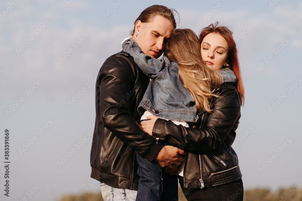 Mother, father and daughter hugging. Family time