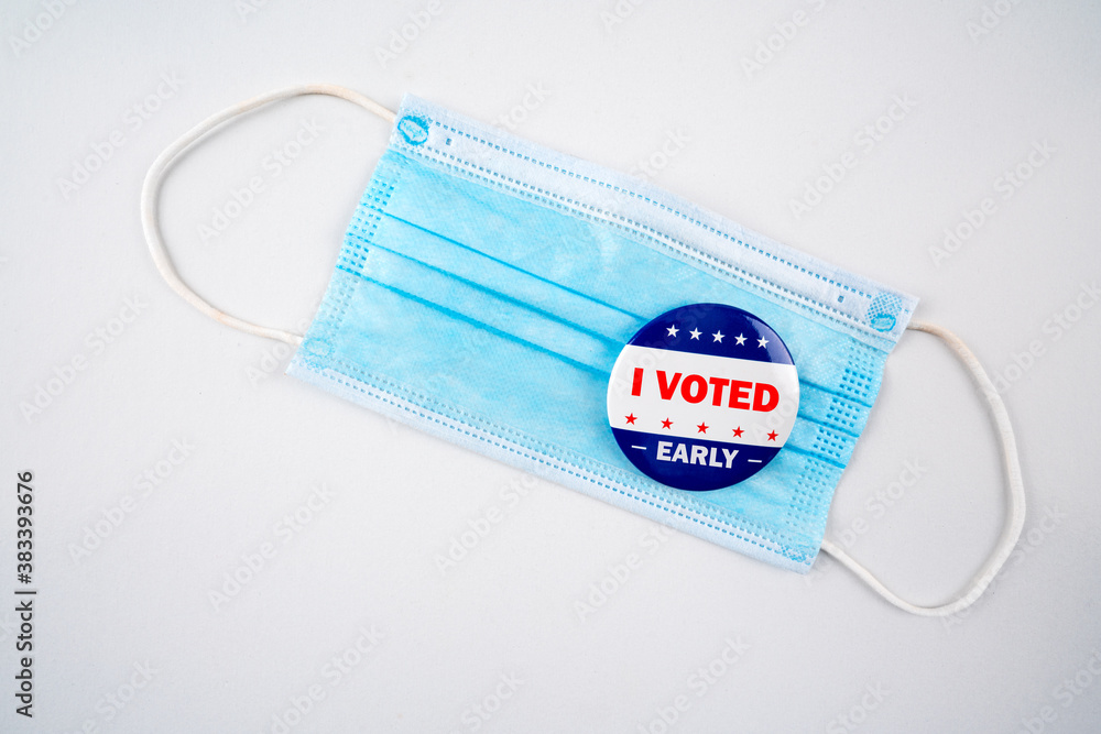 Face mask with american flag colored button with the text i voted early..Voting, covid-19 and presidential election concept 2020. Face mask with american flag colored button with the text i voted early..Voting, covid-19 and presidential election concept 2020.