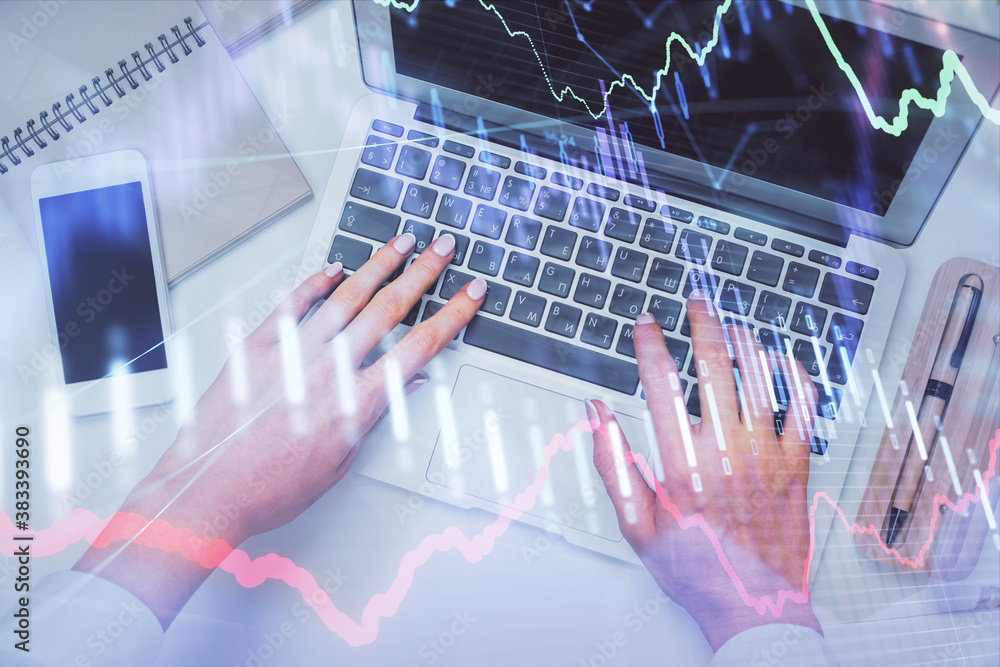 Double exposure of woman hands working on computer and forex graph hologram drawing. Top View. Financial analysis concept. Double exposure of woman hands working on computer and forex graph hologram drawing. Top View. Financial analysis concept.