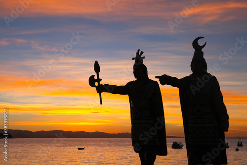 Silhouette of Inca statues during sunset over Lake Titicaca in Copacabana, Bolivia