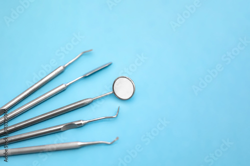 Set of dental instruments on a blue background. Selective focus.