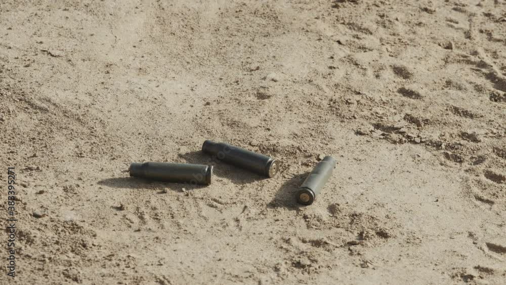 Gun bullet cases falling on the ground. Concept of war, army and military. Gun bullet cases falling on the ground. Concept of war, army and military.