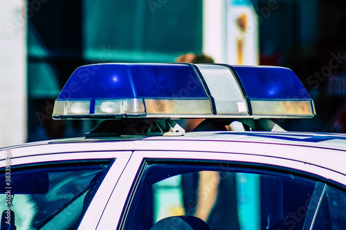 Closeup of an official police car patrolling the streets of the city center of the metropolitan area
