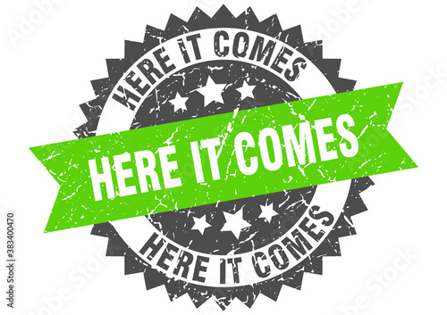 here it comes stamp. grunge round sign with ribbon