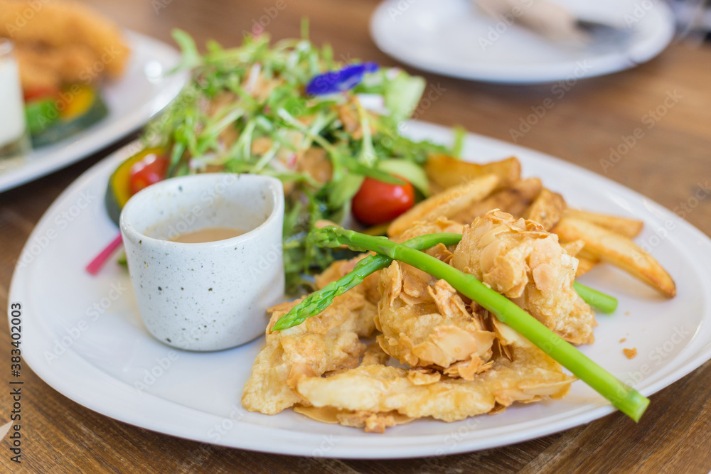 Crispy Almond Fish Steak ( Deep-fried sea fish with almond crispy) with fresh salads is a healthy delicious food.