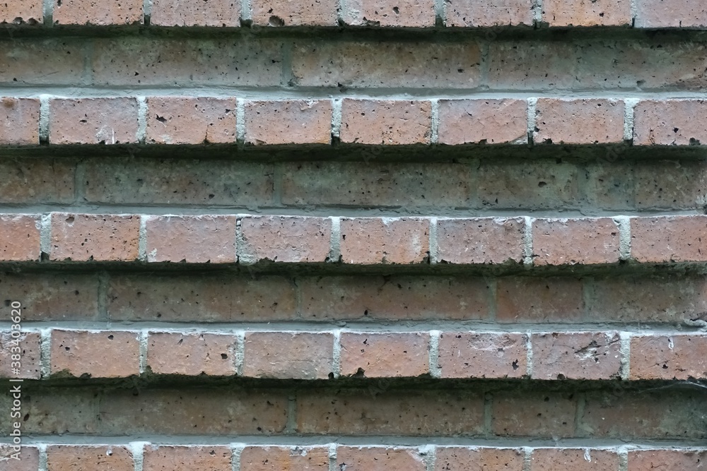 Photo of a fragment of a brick wall. Masonry with relief stripes. In gray and red tones. Photo of a fragment of a brick wall. Masonry with relief stripes. In gray and red tones.