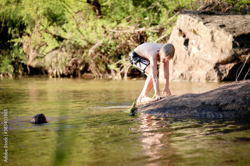 Two boys swimming in the Goulburn River  New South Wales Australia. Holiday photos on Australian road trip.