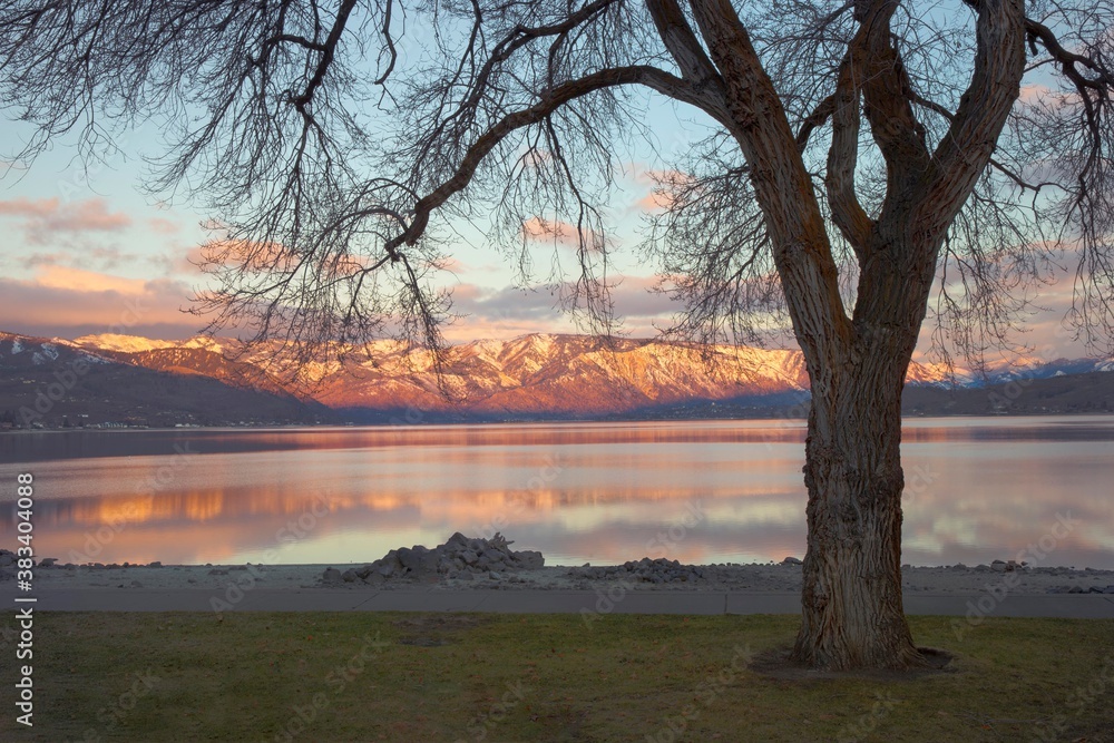 Sunrise over lake Chelan in eastern washington with the snowy cascade mountains in the background. lonely, single desolate area