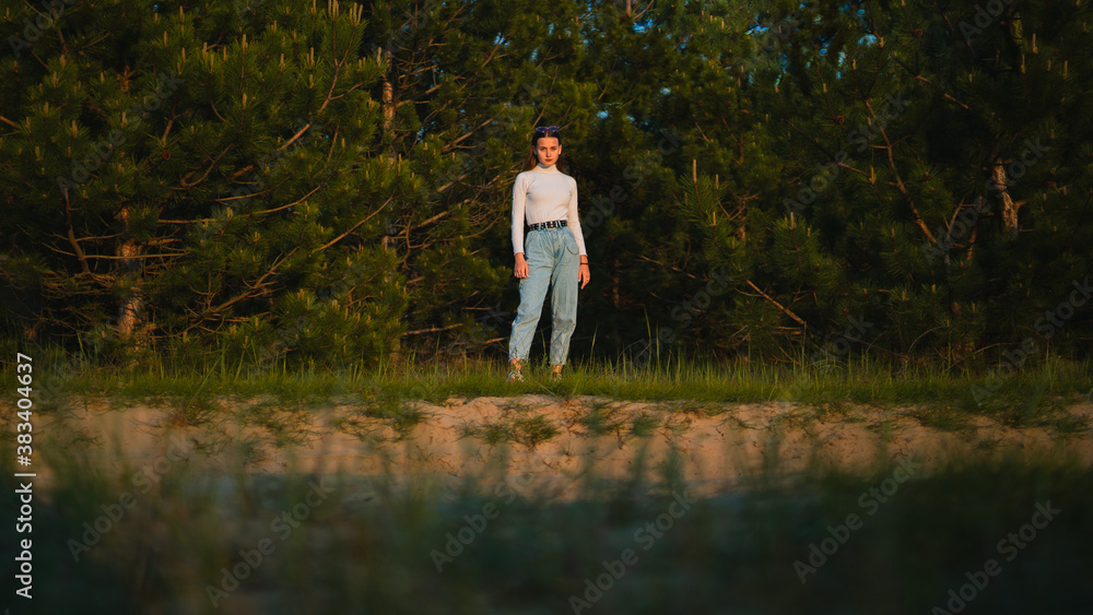 Charming girl among the pine trees in sunset Charming girl among the pine trees in sunset