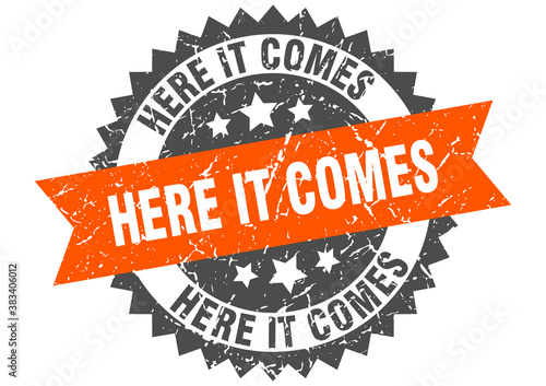 here it comes stamp. grunge round sign with ribbon