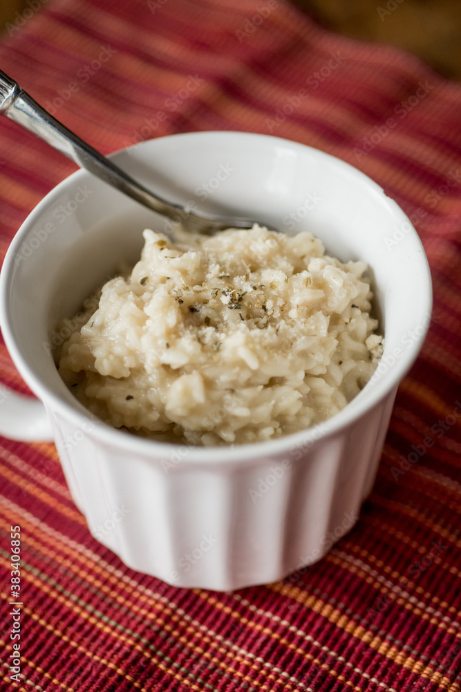 Spoon in a bowl of warm risotto Spoon in a bowl of warm risotto
