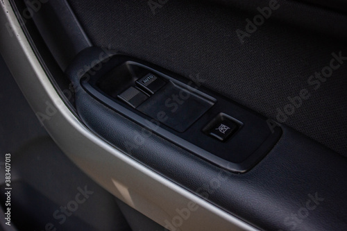 Car arm rest with Control Panel. Door Lock & Mirror Control. window adjustment buttons, door lock. Photography of a modern car. © Muanpare