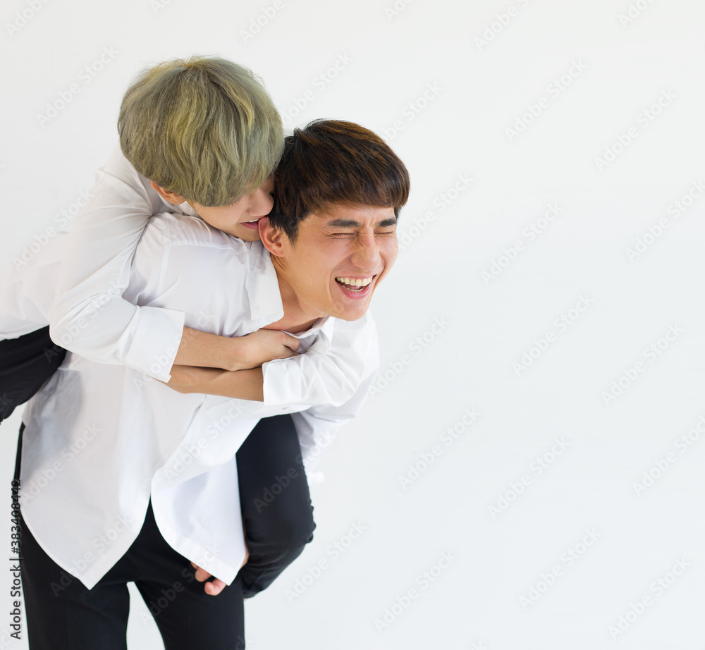 Happy gay couple embracing together isolated on white.