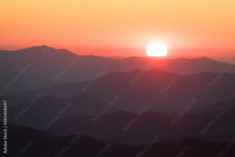 Fototapeta premium Endless layers of fog and trees within the blue ridge mountains of north carolina. Overlooks give way to a sea of mountains and hills filled with fall color during colorful sunrise and sunsets.