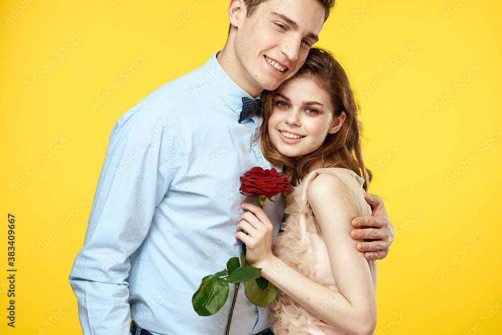 Enamored man and woman with red rose on yellow background cropped view close-up romance Enamored man and woman with red rose on yellow background cropped view close-up romance