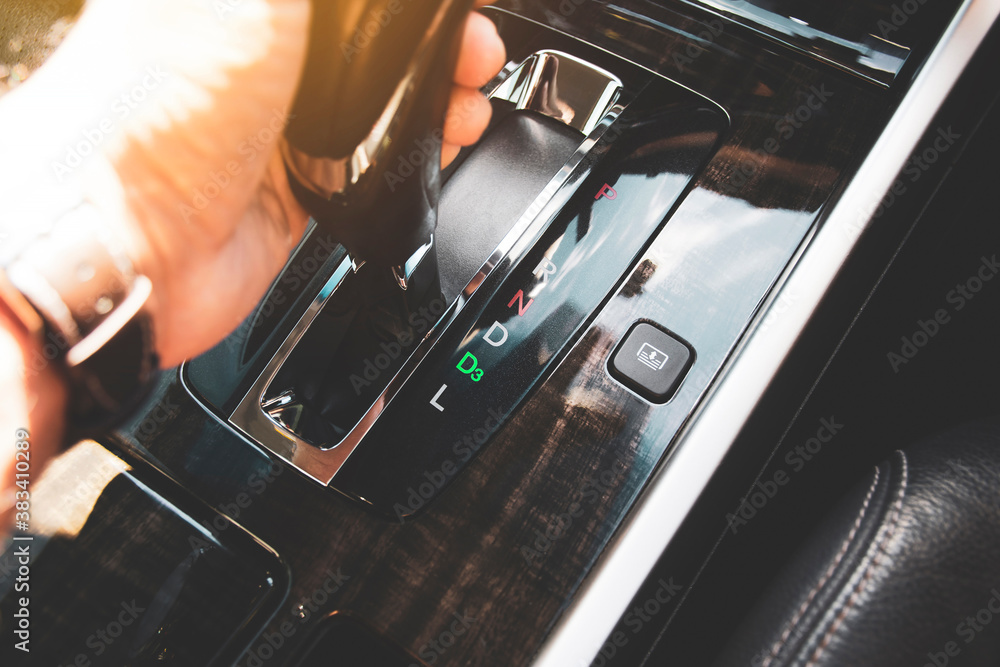 The driver's hand moved the gear selector to the drive three (D3) mode of the automatic transmission in the car The driver's hand moved the gear selector to the drive three (D3) mode of the automatic transmission in the car