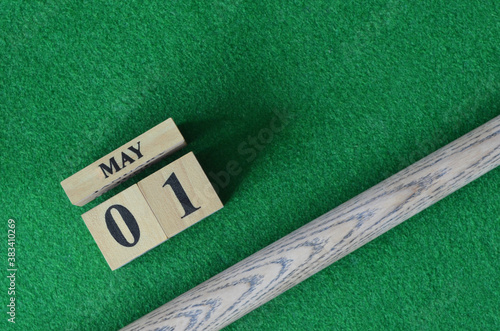 May 1, Number cube With a snooker stick on a green background, snooker table.