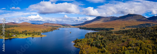 Fototapeta Naklejka Na Ścianę i Meble -  aerial drone image of loch tulla in the argyll region of the highlands of scotland during autumn on a clear bright day showing calm waters on the inland loch