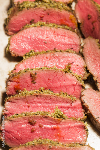 Close up steak venison cooked medium rare for dinner group.