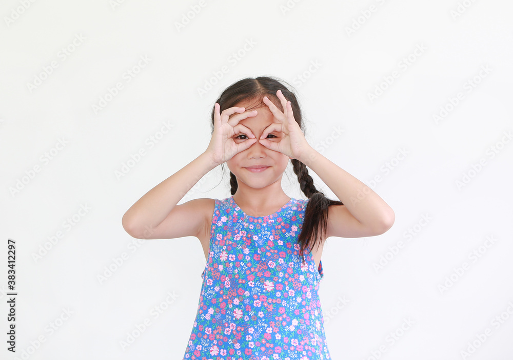 Asian little child girl with hands glasses in front of her eyes isolated on white background. Kid looking through imaginary binocular. Asian little child girl with hands glasses in front of her eyes isolated on white background. Kid looking through imaginary binocular.