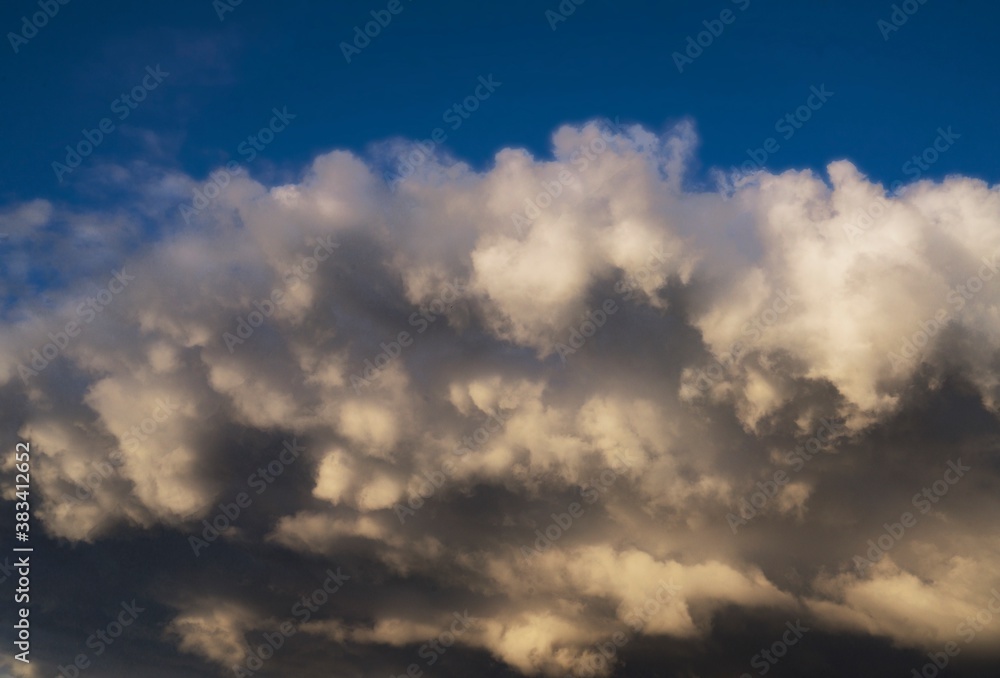 This image shows large rain clouds threatening a bright blue sky.