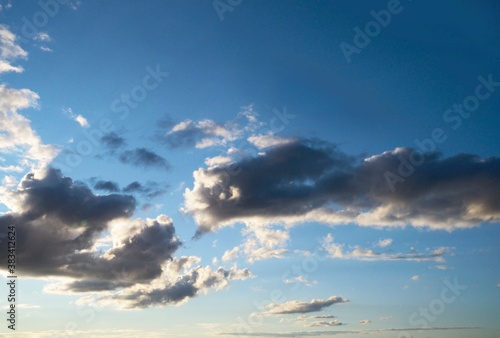 This nature image shows white clouds scattered through a blue sky.