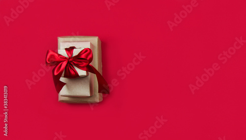 Christmas gift boxes with red ribbons on a red banner background. Christmas and new year banner. Flat lay, top view, copy space, banner