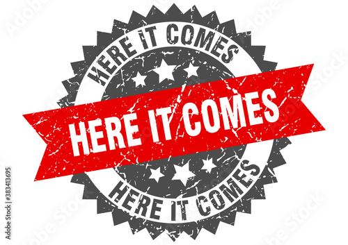 here it comes stamp. grunge round sign with ribbon