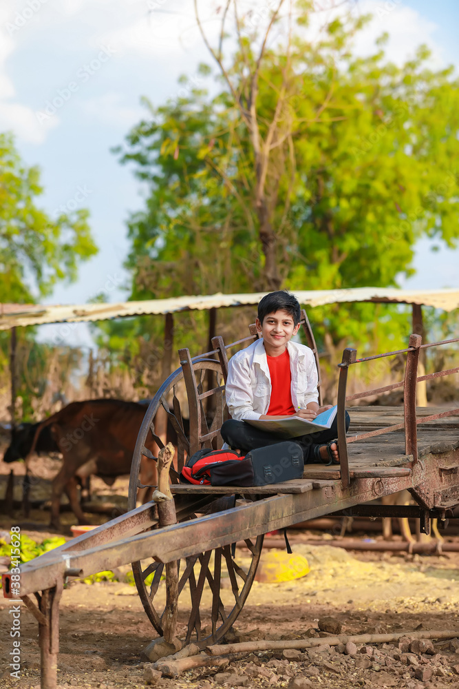 little boy seating on bull cart and studying little boy seating on bull cart and studying