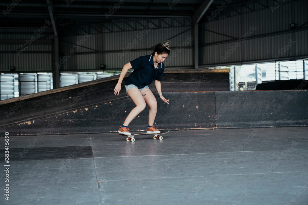 Skate board player woman moving on a board.