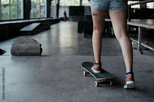 Skate board player woman moving on skateboard.