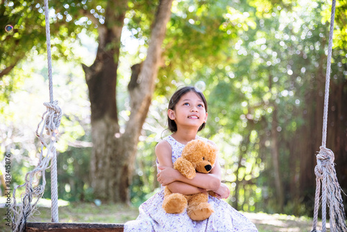 Konstfotografi Happy Child hug teddy bear in green park playground