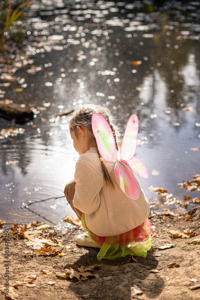 Moscow /Russia -10 04 2020: Happy child resting and walking in nature in the autumn forest near the lake in Moscow region of Russia with yellow and orange autumn leaves