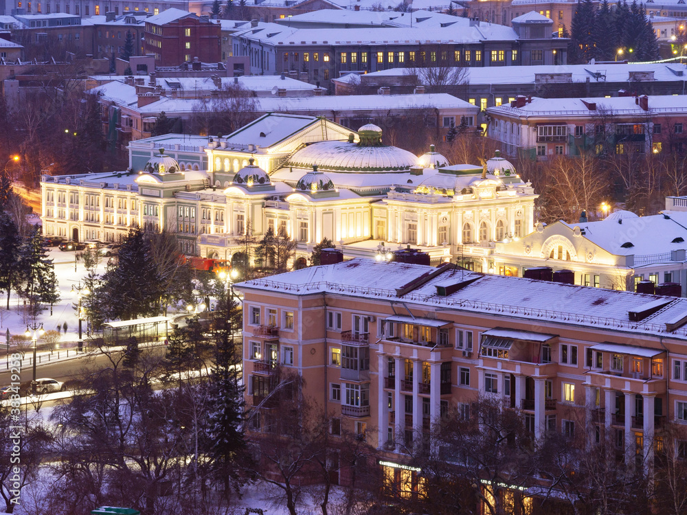 Drama Theater in Omsk in the winter evening. The building of the drama theater from a height with the backlight on.