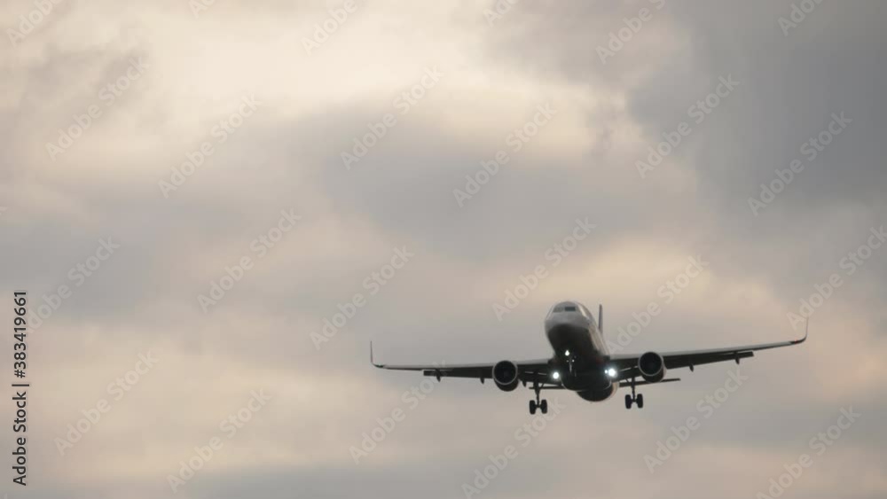 Airliner on final approach. View from the runway's edge