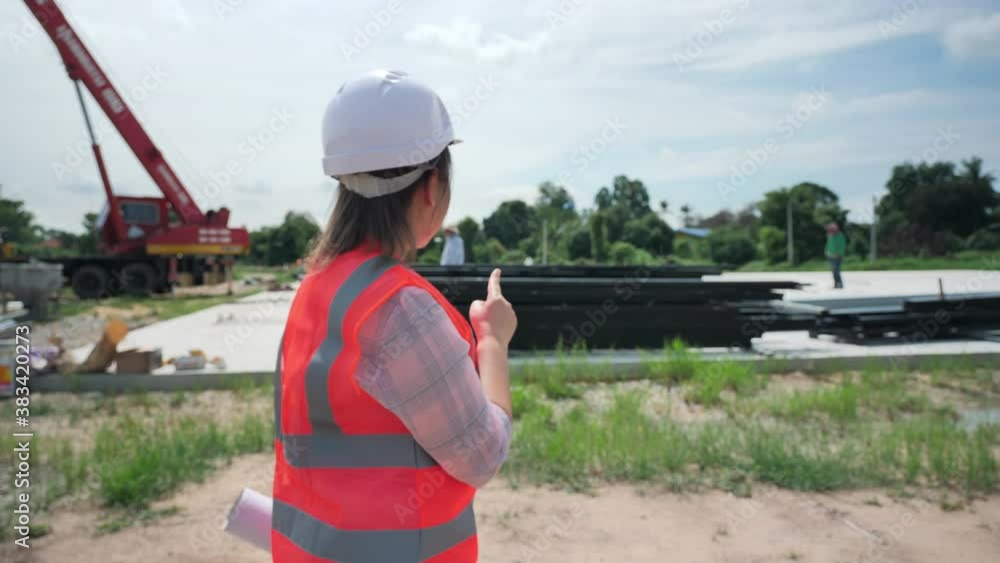 Asian woman engineer walk check building materials for building a warehouse. Slow Motion Asian woman engineer walk check building materials for building a warehouse. Slow Motion