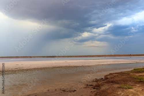 Dark storm clouds over a salt lake before a rain