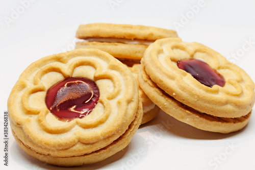 several biscuits with jam in the middle on white background