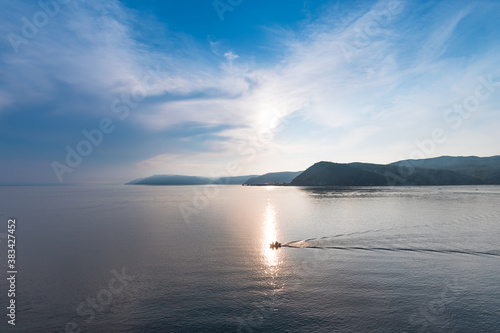 Sunset at the source of the Angara River from Lake Baikal. Baikal port and mountains. Listvyanka, Irkutsk region, Siberia, Russia