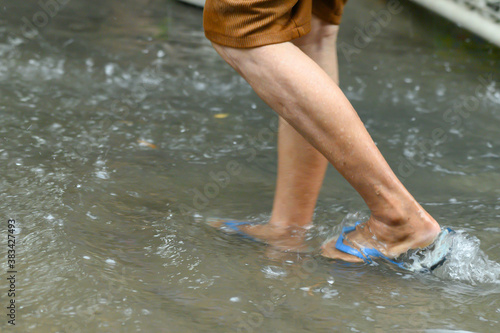 Legs walking through the flood