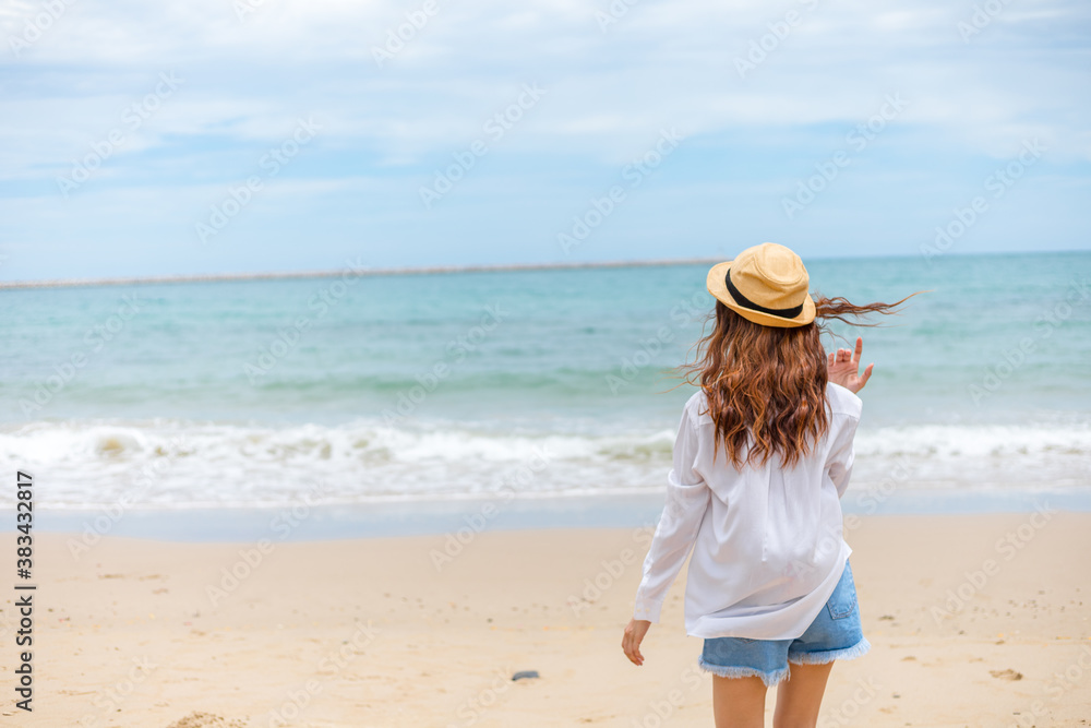 Happy young girl walking on the beach. Summer travel, vocation, holiday concept.
