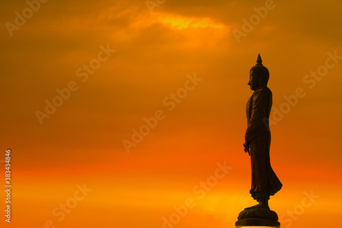 Sunday Buddha and sunset orange cloud on sky on the Asanha bucha day