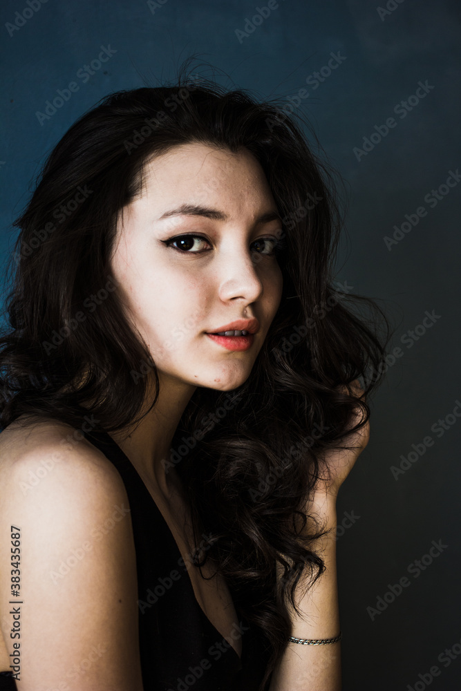 Black hair woman. Beautiful brunette hairstyle fashion portrait over dark background Black hair woman. Beautiful brunette hairstyle fashion portrait over dark background