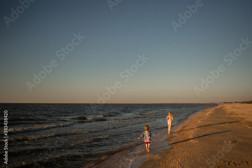 Canvas Print children run along the shore of the sea of Azov