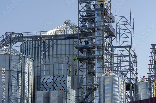 Construction of a modern grain terminal on a blue sky background.