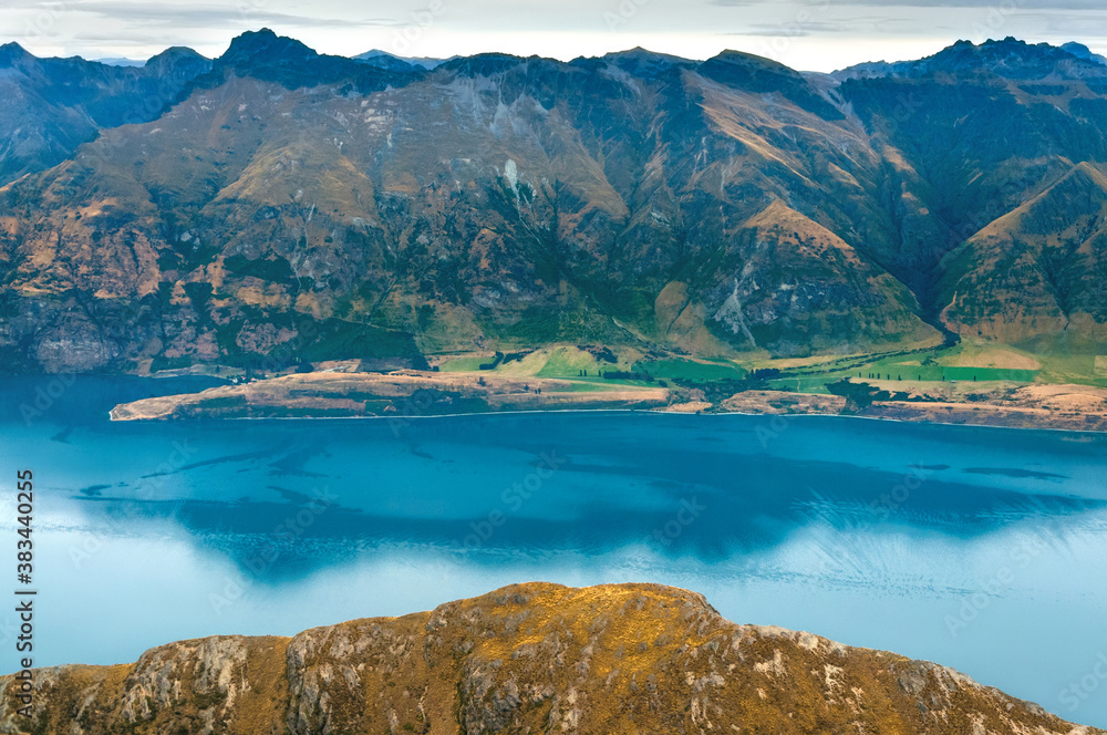 Amazing aerial view of clear blue waters of Wakatipu lake and mountains near Queenstown, beautiful landscape of New Zealand