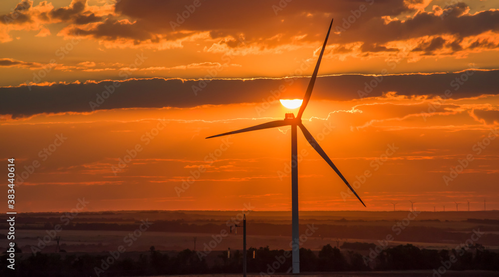 Obraz premium Wind turbines that generate electricity. Eco-friendly electricity. Sunset
